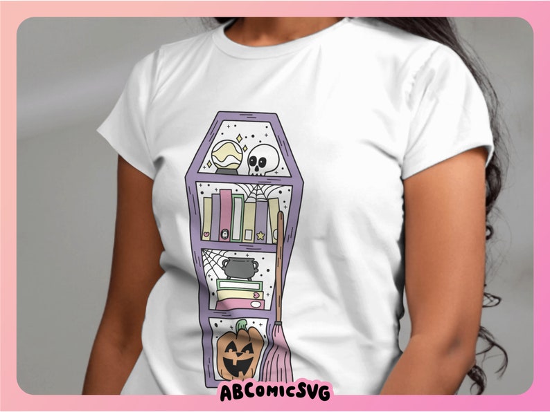 May include: A white t-shirt featuring a purple coffin-shaped bookshelf design. The bookshelf is filled with books, a cauldron, a skull, a crystal ball, and a broom. The text "ABCOMICSVG" is at the bottom of the design.