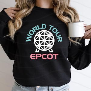 May include: Black sweatshirt with a white graphic of the Epcot ball and the text "World Tour Epcot" in blue and pink.