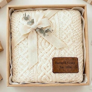 May include: A white ceramic mug with a black handle and the text "But First, Coffee" in a handwritten style. The mug is on a white surface. The mug is 4 inches tall.