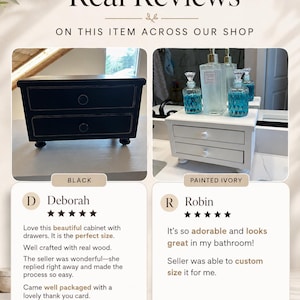 May include: A two-drawer cabinet shown in black and painted ivory finishes. The black cabinet features two round knobs and four small feet. The ivory cabinet is displayed with glass bottles on top, also featuring two round knobs and four feet.