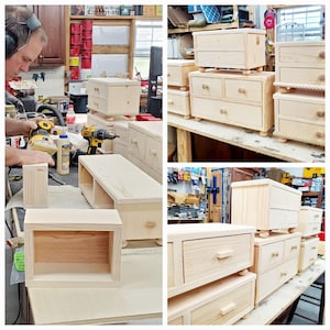 May include: A collection of unfinished light-colored wooden storage chests and small drawer units in various stages of assembly. The pieces feature natural wood grain, rounded feet, and simple wooden knobs, displayed in a workshop environment.
