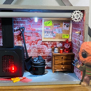 May include: A miniature diorama of a basement with a brick wall, a black metal furnace, a shovel, a bucket of coal, a wooden dresser, a red lantern, and a Freddy Krueger Funko Pop figure.