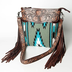 May include: A brown leather handbag with a turquoise and green woven pattern and fringe detail. The bag has a tooled leather flap with floral designs.