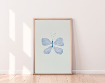 May include: A framed print of a watercolor painting of a blue butterfly on a light blue background.