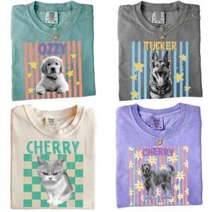 May include: Four Comfort Colors t-shirts with pet-themed designs. The shirts are teal, gray, cream, and purple. Each shirt features a pet's name and image: "Ozzy" with a puppy, "Tucker" with a German Shepherd, "Cherry" with a cat, and "Cherry" with a dog.