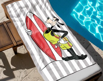 May include: A gray and white striped beach towel with a cartoon image of Goofy holding a red surfboard. Goofy is wearing a yellow shirt and red shorts.