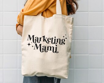 May include: A white canvas tote bag with black text that reads "Marketing Mami" with two small stars on either side of the text.