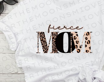May include: White t-shirt with the text "fierce MOM" in black letters. The letters are decorated with a leopard print pattern in brown, orange, and pink.