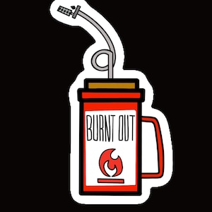 May include: A red and white mug with a black handle and the words "BURNT OUT" printed on the front. A flame graphic is below the text. A gray straw with a silver top is sticking out of the mug.
