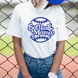 May include: White t-shirt with a blue softball graphic and the text "Softball Mama" in a retro font.