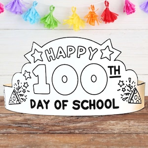 以下が含まれることがあります： 星形のデザインが施された、黒と白の紙製の王冠で、「Happy 100th Day of School」の文字が書かれています。