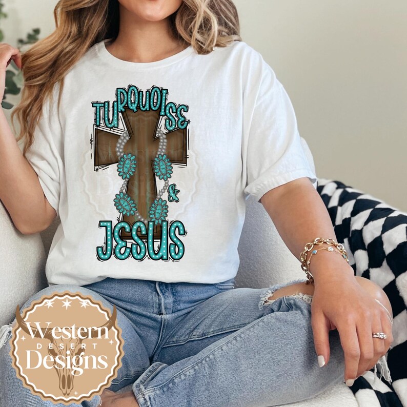 May include: A white t-shirt featuring a turquoise and brown cross design. The cross is adorned with turquoise stones and the words "Turquoise & Jesus" are written on it.