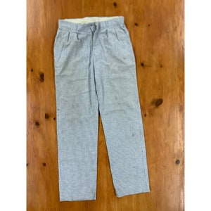 May include: A pair of light grey trousers with a subtle pinstripe pattern. The trousers have a straight leg and a classic fit.