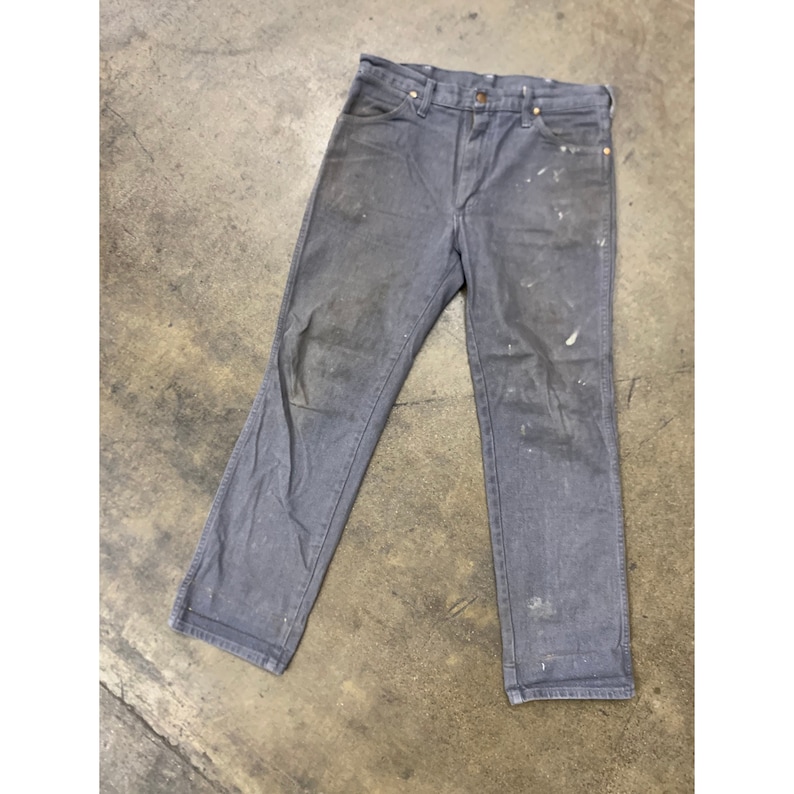 May include: Gray work pants with white paint splatters. The pants have a straight leg and a classic five-pocket design.