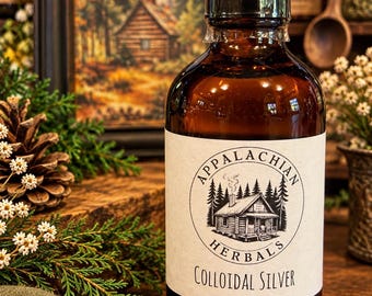 May include: An amber glass bottle with a black cap and a white label. The label features a circular logo with a cabin and forest illustration, the text "APPALACHIAN HERBALS" in a circle, and the words "COLLOIDAL SILVER" printed below.