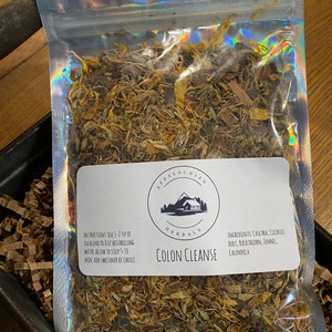 May include: A clear plastic bag filled with a blend of dried herbs for a colon cleanse. The bag has a white label with the text "APPALACHIAN HERBALS COLON CLEANSE" and a list of ingredients: Cascara, Licorice Root, Buckthorn, Fennel, Calendula. Instructions for use are also included on the label.