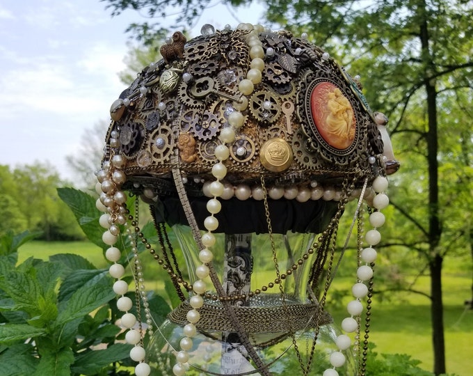Steampunk brass bridal bouquet with gears, watch parts, buttons, cameos, a working pocket watch, and perpetual calendar.
