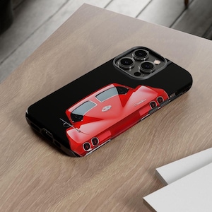 May include: A red classic car phone case for an iPhone 14 Pro Max. The case features a black background and a rear view of a red Corvette.