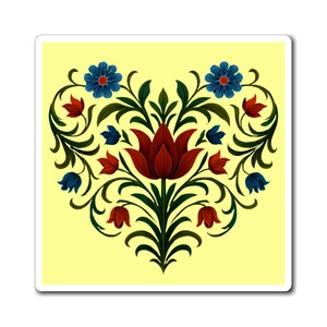 May include: A heart-shaped floral design on a yellow background. The design features a large, dark red central flower with green leaves and stems. Blue and red flowers are arranged around the central flower, creating a symmetrical pattern. The design is likely a sticker or magnet.