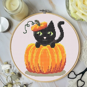 May include: A black cat wearing a pumpkin hat sits inside a large orange pumpkin. The cat has green eyes and a black nose. The pumpkin is on a white background.