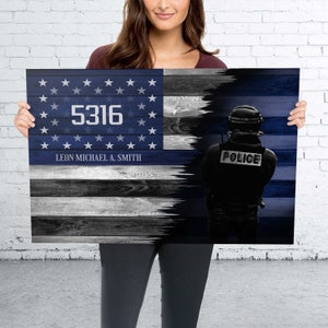 May include: A blue and white American flag with a thin blue line, a police officer silhouette, and the text "5316 LEON MICHAEL A. SMITH" printed on the flag.