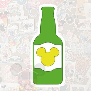 May include: A green sticker in the shape of a beer bottle with a white label and a yellow Mickey Mouse head design. The sticker is surrounded by other colorful stickers with various designs.