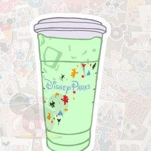May include: A sticker of a green beverage in a clear plastic cup with a white lid. The cup has the words "Disney Parks" in blue script. Colorful shapes and confetti decorate the cup. The background is covered with various stickers.