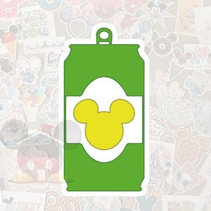May include: A green sticker in the shape of a soda can with a white label and a yellow Mickey Mouse head silhouette. The sticker has a small loop at the top. The background is filled with various Disney-themed stickers.