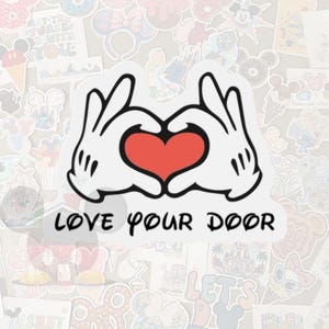 May include: A white sticker featuring Mickey Mouse hands forming a heart with a red center. The text "LOVE YOUR DOOR" is below the heart. The background is filled with various Disney-themed stickers.