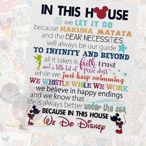 May include: A white sign with colorful text that reads "IN THIS HOUSE We Do Disney." The sign includes phrases like "Let it Go," "Hakuna Matata," and "To Infinity and Beyond." Mickey Mouse silhouettes are featured.