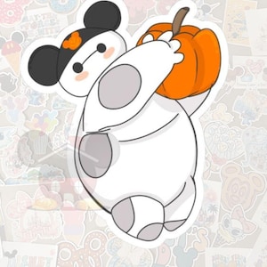 May include: A white sticker featuring a cartoon character holding an orange pumpkin. The character has a black hat with an orange accent and black ears. The sticker has a white background and is surrounded by other stickers.