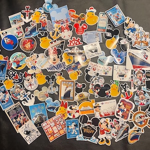 May include: A selection of colourful Disney-themed stickers featuring Mickey and Minnie Mouse, cruise ships, anchors, and nautical elements. The stickers vary in size and shape, some with the Disney Cruise Line logo.