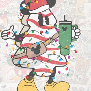 May include: A cartoon illustration of Mickey Mouse in the shape of a Christmas tree, wearing a Santa hat and holding a green tumbler. The tree is decorated with red stripes and colorful lights. A brown fanny pack with a Mickey Mouse icon is around the waist.