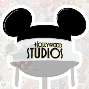 May include: A white sticker featuring a stylized Mickey Mouse head with black ears. The design incorporates a water tower shape with the words "HOLLYWOOD STUDIOS" in gold lettering. The background is filled with various colorful stickers.