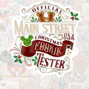 May include: A sticker with the text "OFFICIAL Main Street Christmas U.S.A. Cookie Tester." The design includes gingerbread men, a Mickey Mouse head with Christmas lights, holly, and a snowman. The sticker has a white background with other stickers in the background.