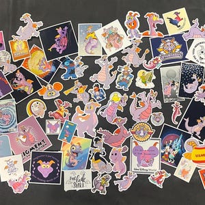 May include: A collection of colourful stickers featuring the character Figment from Disney's Epcot. The stickers showcase Figment in various poses and designs, with text like "Imagination" and "Disney World". The stickers are in shades of purple, orange, and blue.