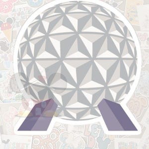 May include: A sticker featuring a geometric sphere design in shades of gray, supported by two purple trapezoids. The sticker has a white border and is surrounded by other colorful stickers.