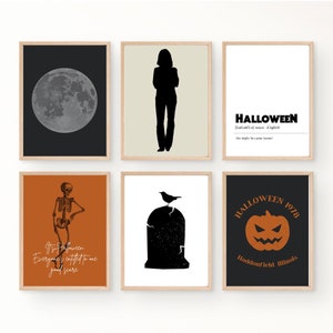 May include: Six framed Halloween-themed prints with various designs, including a full moon, a silhouette of a person, a skeleton, a tombstone with a crow, a pumpkin, and a text-based design that says "HALLOWEEN".