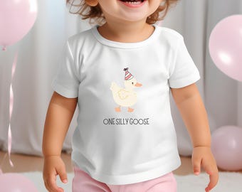 May include: A white t-shirt with a cartoon goose wearing a party hat. The text "ONE SILLY GOOSE" is printed below the goose.