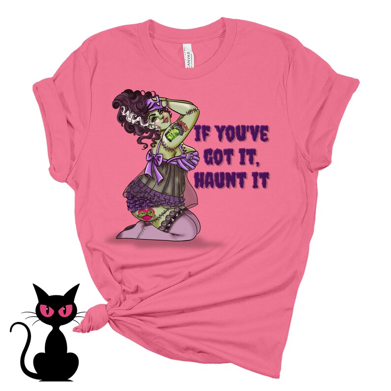 May include: Pink t-shirt with a green and purple illustration of a woman with stitches and the text "If you've got it, haunt it."
