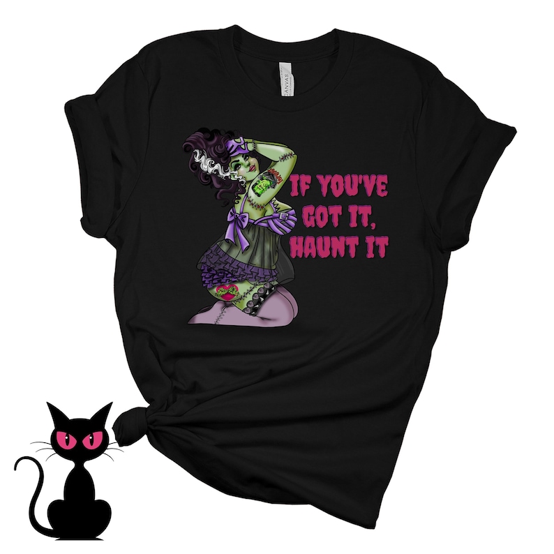 May include: Black t-shirt with a green and purple illustration of a woman with stitches and the text "If you've got it, haunt it."
