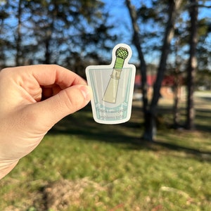 May include: A sticker of a lighthouse in a glass with the text "Think I will cause problems today".