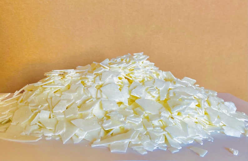 May include: A large pile of white wax flakes, likely for candle making.