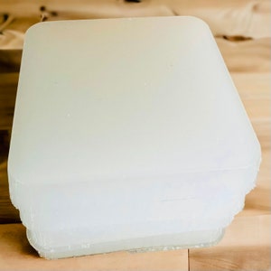 May include: A stack of clear, rectangular, frosted acrylic sheets. The sheets are stacked on top of each other, with the top sheet being the largest.