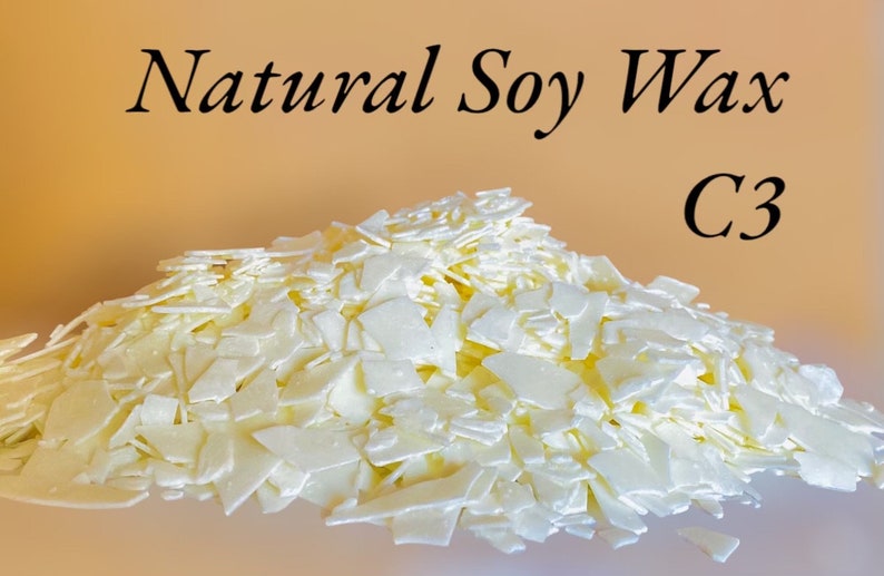 May include: A close-up of a pile of white soy wax flakes. The wax is labeled "Natural Soy Wax C3".
