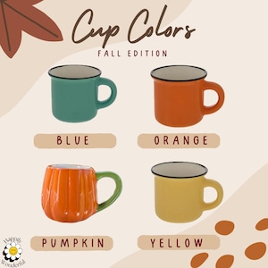 May include: A collection of four ceramic mugs labeled Cup Colors Fall Edition. Three mugs have a smooth finish in blue, orange, and yellow with black rims. One mug is shaped like a pumpkin with orange vertical ridges and a green handle.