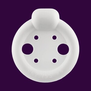 May include: A white, circular object with a raised top and several holes. The object has a smooth texture and is set against a purple background. The text "KK2.755" is visible on the object.