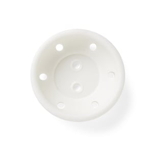 May include: A top-down view of a small, off-white, round plant pot. The pot has six evenly spaced drainage holes around the rim and three drainage holes in the center. The pot is made of a smooth, matte material.