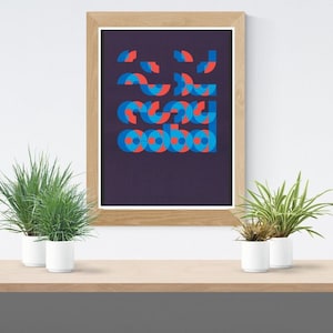 May include: A framed print with a geometric design of overlapping circles in shades of blue and red on a dark purple background.