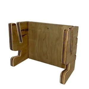 May include: Wooden wall mount with two slots for holding a pair of skis or snowboards. The mount is made of plywood and has a natural wood finish.